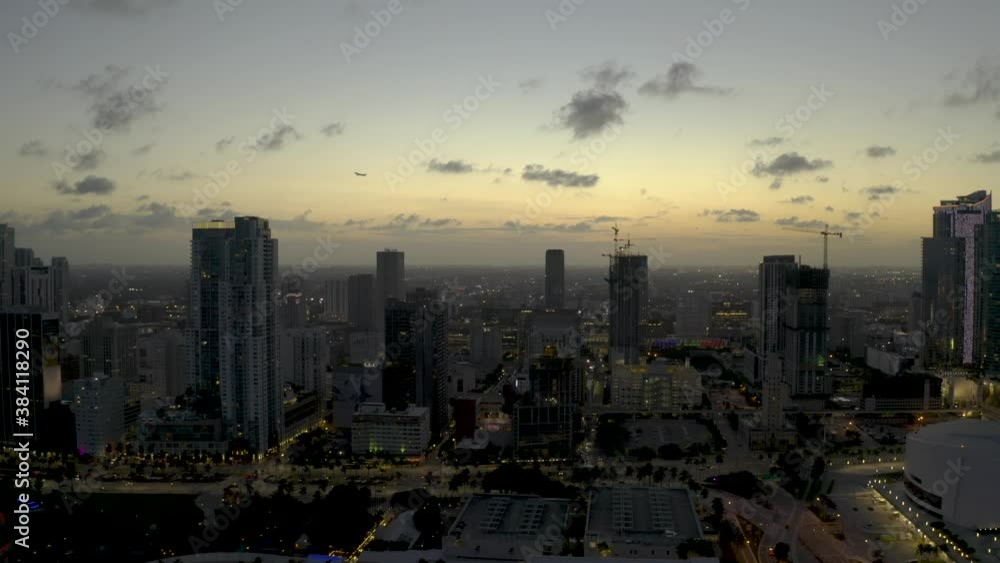 Airplane flying over Downtown Miami city landscape twilight Airplane flying over Downtown Miami city landscape twilight