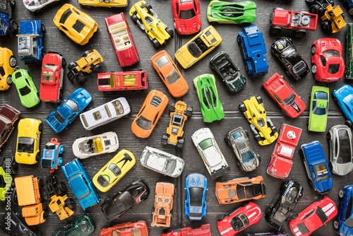 Photos Overhead view on colorful car toys. Many multi-colored.