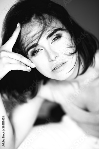 Beautiful young stylish ginger woman with freckles. Fashion black and white portrait of charming girl wearing casual clothes posing at home. Passion © Khorzhevska