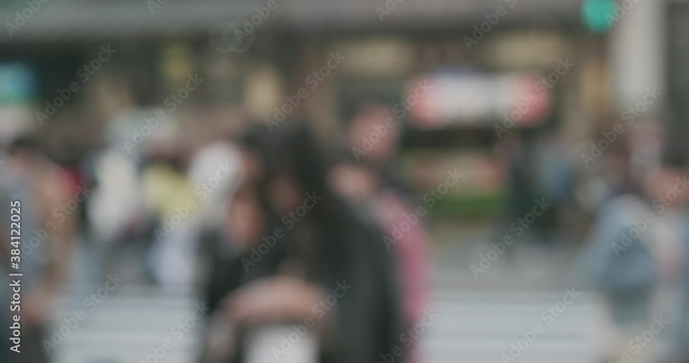 Blurred people crowded street. Large crowd of busy pedestrians crossing slow motion in defocus Blurred people crowded street. Large crowd of busy pedestrians crossing slow motion in defocus