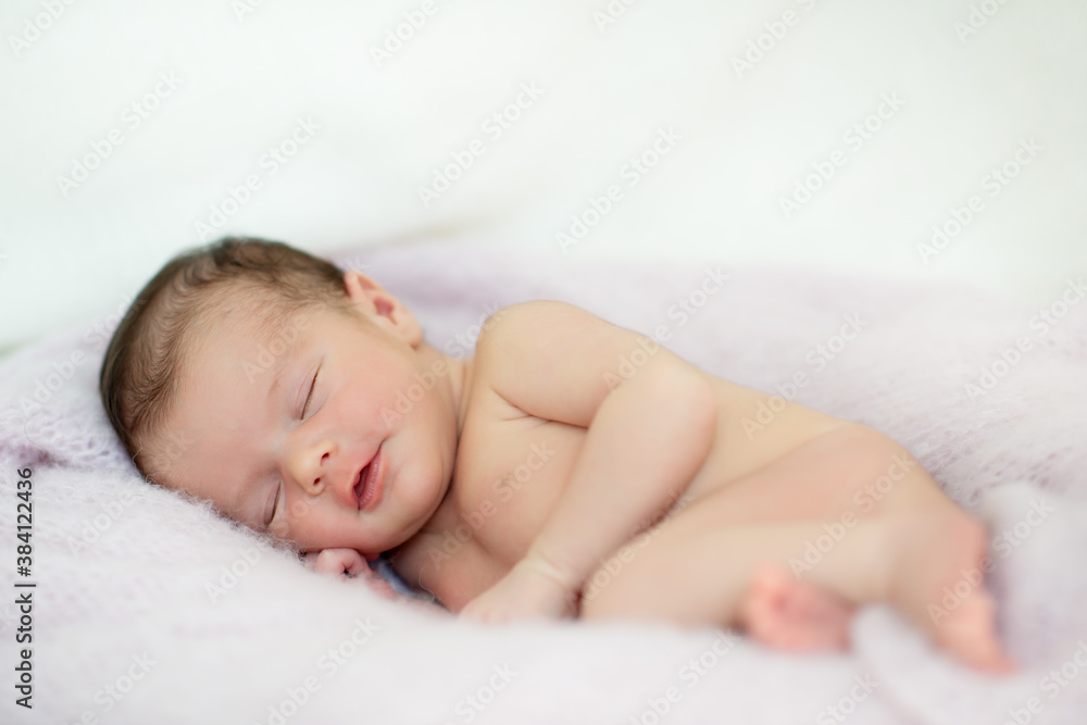 New born baby girl sleeps at home and smiling in a dream. Cute little kid's portrait New born baby girl sleeps at home and smiling in a dream. Cute little kid's portrait