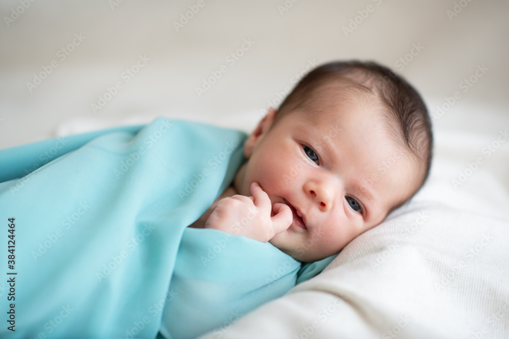 New born baby girl smiling and looking at camera. Cute little kid's portrait New born baby girl smiling and looking at camera. Cute little kid's portrait