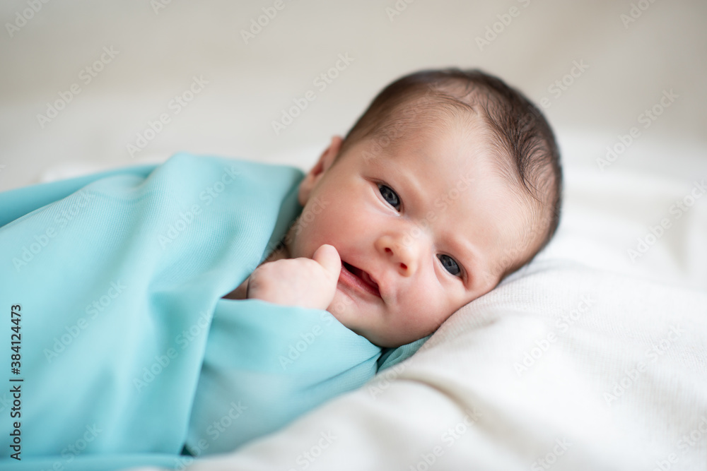 New born baby girl smiling and looking at camera. Cute little kid's portrait New born baby girl smiling and looking at camera. Cute little kid's portrait