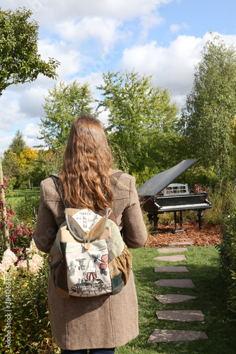 Park Tsaritsyno in Moscow city, Russia. Tsaritsino Festival of Historical Gardens 2020. Russian tourist woman with backpack. Moscow urban garden, landscape. Flowers decor, floral decoration. Landmark photo