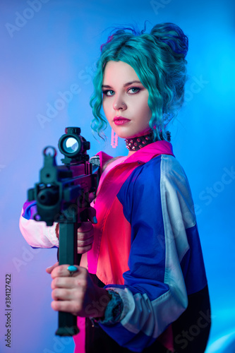 a bright female hooligan in a tracksuit with an automatic rifle in the bright neon light