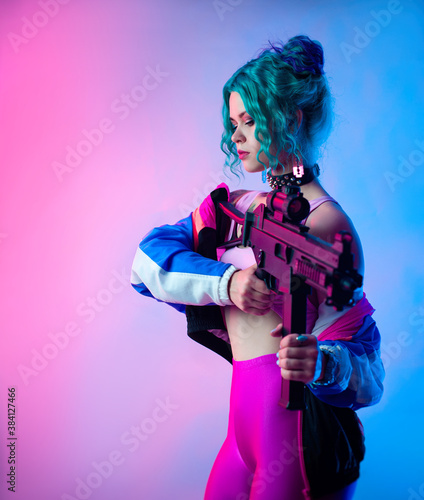a bright female hooligan in a tracksuit with an automatic rifle in the bright neon light