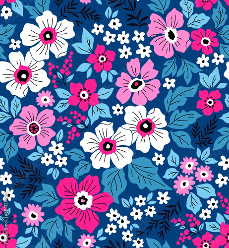 Trendy seamless vector floral pattern. Endless print made of small white and pink flowers. Summer and spring motifs. Blue background. Vector illustration.