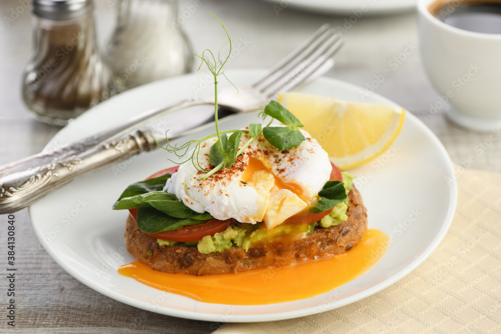 Eggs Benedict with guacamole on cereal bread Eggs Benedict with guacamole on cereal bread