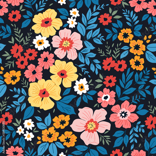 Trendy seamless vector floral pattern. Endless print made of small colorful flowers and blue leaves . Summer and spring motifs. Black background. Vector illustration.