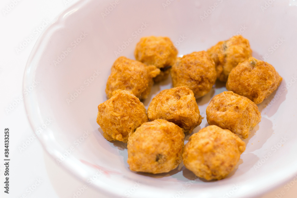 Fried premium shrimp ball made from fresh shrimp suitable to be served with noodles on a white plate. Selective focus with shallow depth of field on the top view. Delicious crispy shrimp balls. Fried premium shrimp ball made from fresh shrimp suitable to be served with noodles on a white plate. Selective focus with shallow depth of field on the top view. Delicious crispy shrimp balls.