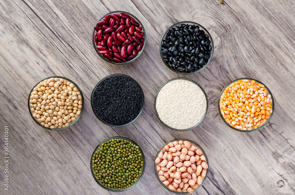 Cereal grains seeds beans on wooden background. Whole grains and bean. Cereals and beans. Different dry legumes for eating healthy. Peanut , Black bean, Red Bean. Green Bean, Soybean, sesame Cereal grains seeds beans on wooden background. Whole grains and bean. Cereals and beans. Different dry legumes for eating healthy. Peanut , Black bean, Red Bean. Green Bean, Soybean, sesame