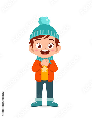 happy cute little kid play and wear jacket in winter season. child smile wearing warm clothes