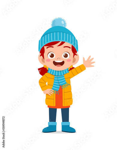 happy cute little kid play and wear jacket in winter season. child smile wearing warm clothes