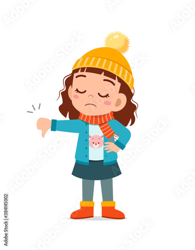 happy cute little feel disappointed and wear jacket in winter season. child use thumb down and wearing warm clothes