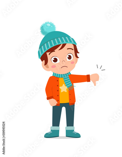 happy cute little feel disappointed and wear jacket in winter season. child use thumb down and wearing warm clothes