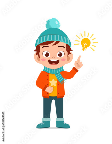 happy cute little have idea and wear jacket in winter season. child thinking and wearing warm clothes