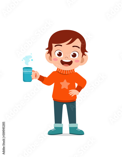 happy cute little kid drink hot chocolate in winter season. child drink milk wearing warm clothes