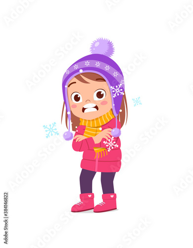 happy cute little kid play and wear jacket in winter season. child feeling chill wearing warm clothes