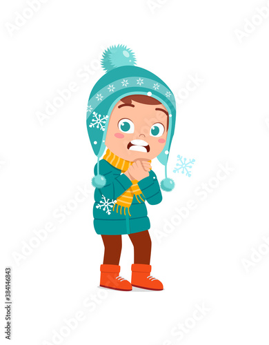 happy cute little kid play and wear jacket in winter season. child feeling chill wearing warm clothes