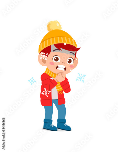 happy cute little kid play and wear jacket in winter season. child feeling chill wearing warm clothes