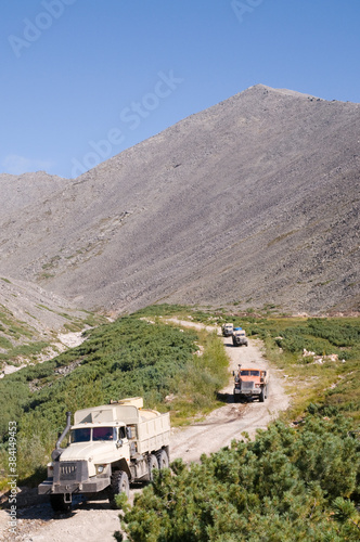 Trucks - fuel trucks go down bad roads from a mountain pass. They carry fuel for gold miners who work in remote areas of Eastern Siberia