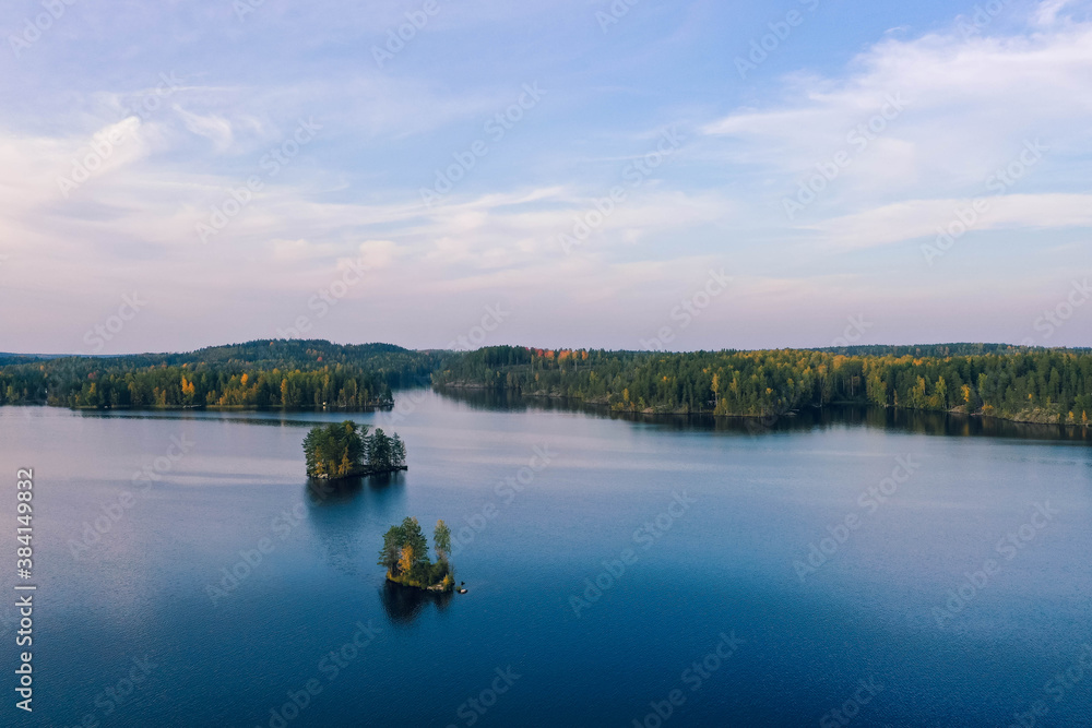 Drone shot of islands, lake and forest in autumn in Heinola, Finland