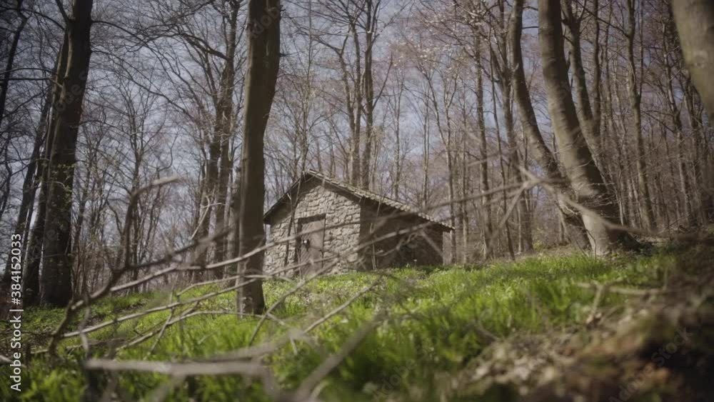 Stone wall house in front of woods Stone wall house in front of woods
