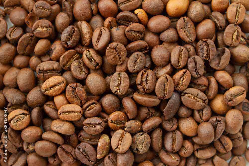 Naklejka premium Dark brown Roasted coffee beans background, top view texture