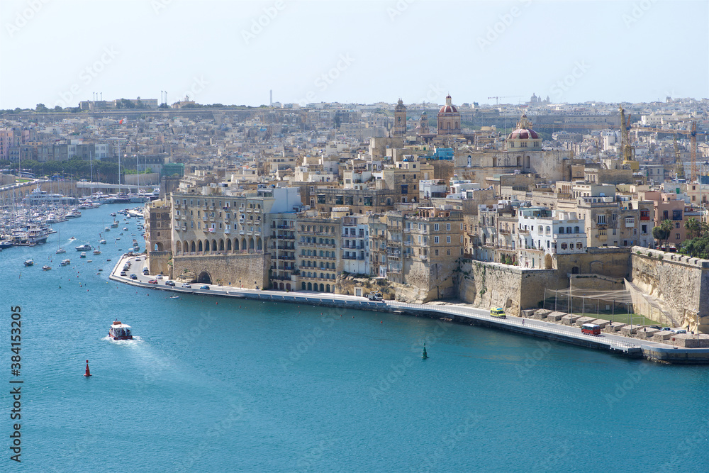 Senglea, Malta - 8 nov,2015: ferry going to pier at Senglea, Malta. Panoramic view of nice old city Senglea in Malta, Europe. Ferry Valletta -Bormla Senglea, Malta - 8 nov,2015: ferry going to pier at Senglea, Malta. Panoramic view of nice old city Senglea in Malta, Europe. Ferry Valletta -Bormla