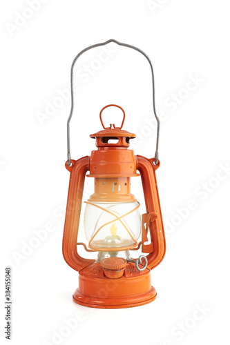 Vintage orange oil lamp with a flame