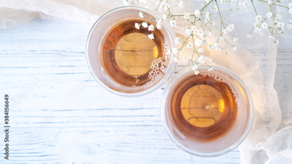 Summer tea on wooden table. Black tea in glass cups. Morning tea in mugs with place for text. Top view background Summer tea on wooden table. Black tea in glass cups. Morning tea in mugs with place for text. Top view background