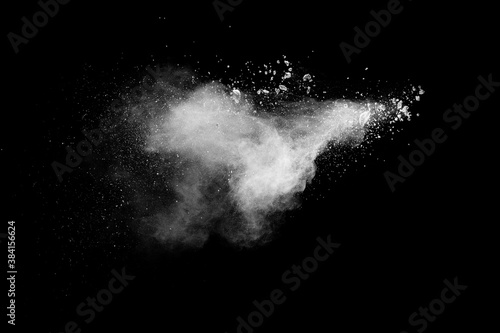 White powder explosion clouds.Freeze motion of white dust particles splash on black background.