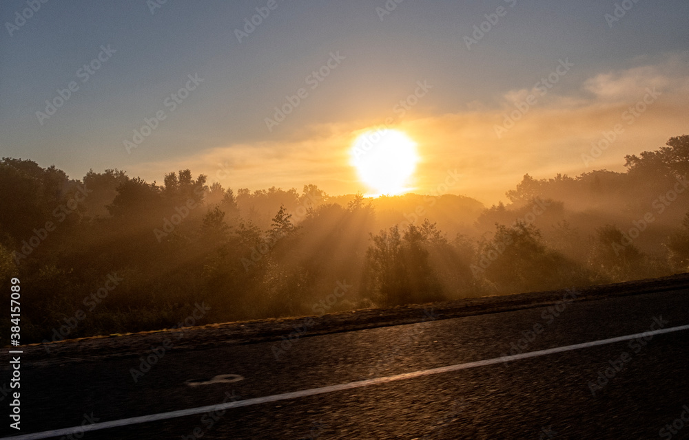 Foggy Landscape.Early Morning Mist. background of the sun.