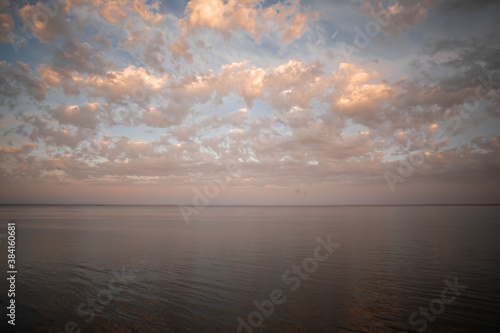 Golden sunset with colorful sky and colorful water in lake reflected in evening