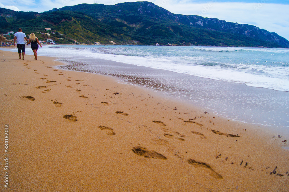 Corfu, Greece, couple walking on the beach 