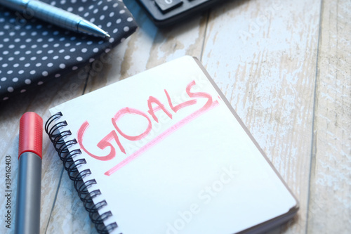 top view of new year goals text on notepad.