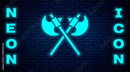 Glowing neon Crossed medieval axes icon isolated on brick wall background. Battle axe, executioner axe. Medieval weapon. Vector.