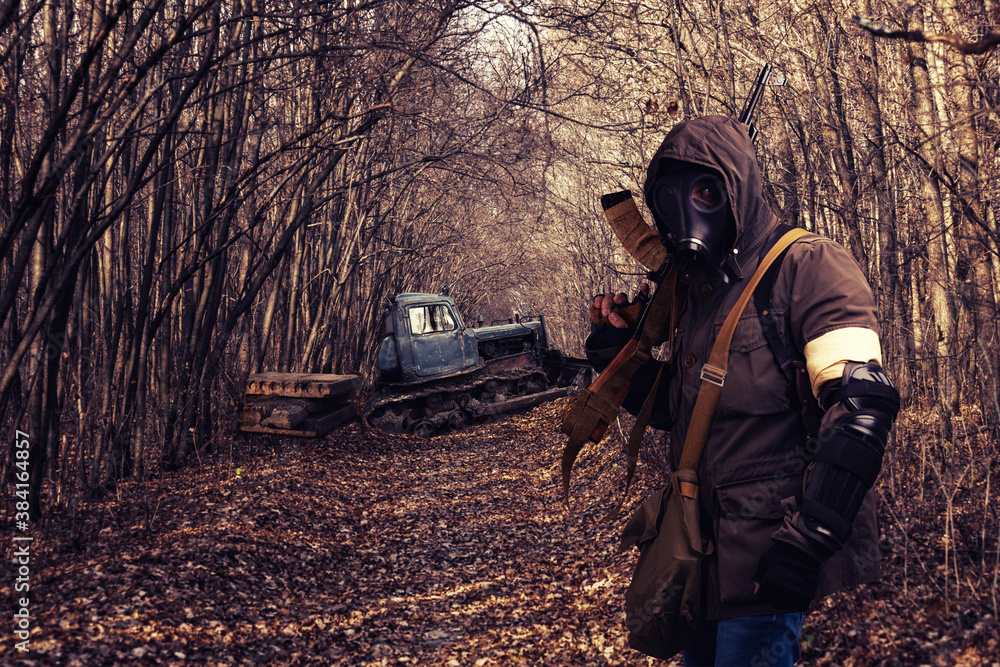 man in gas mask wandering through forest. man in gas mask wandering through forest.