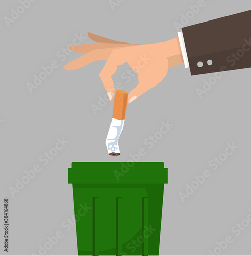 Hand putting cigarettes in trash bin concept