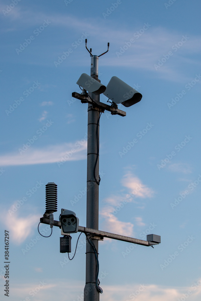 modern weather vane, against blue sky modern weather vane, against blue sky