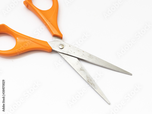 Orange scissor with white background.