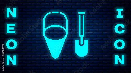Glowing neon Fire shovel and cone bucket icon isolated on brick wall background. Vector.