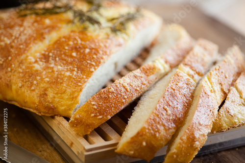 Detail photo of sliced italian bread on a cutting board. Selective focus - shallow depth of field.