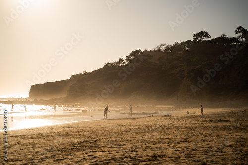 Wallpaper of Falesia beach with golden sand and fog at sunset Algarve, Portugal. photo