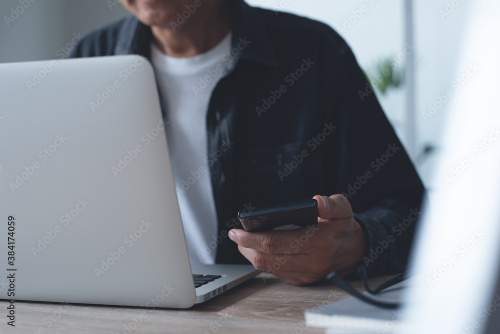 Casual business man surfing the internet working on laptop computer from home office Casual business man surfing the internet working on laptop computer from home office