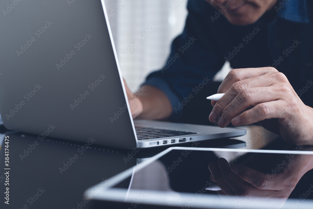 man, surfing the internet online working on laptop computer from home office man, surfing the internet online working on laptop computer from home office