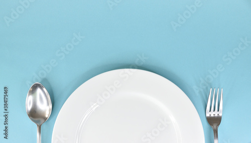 A tablespoon and fork are laid out on either side of the white plate.