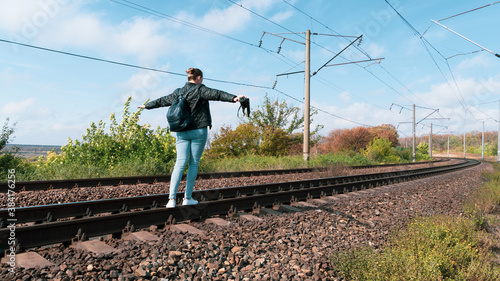 Woman walking on rails