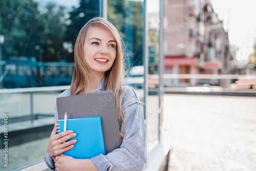 Girl student smiling and looking to the side at copy space for text