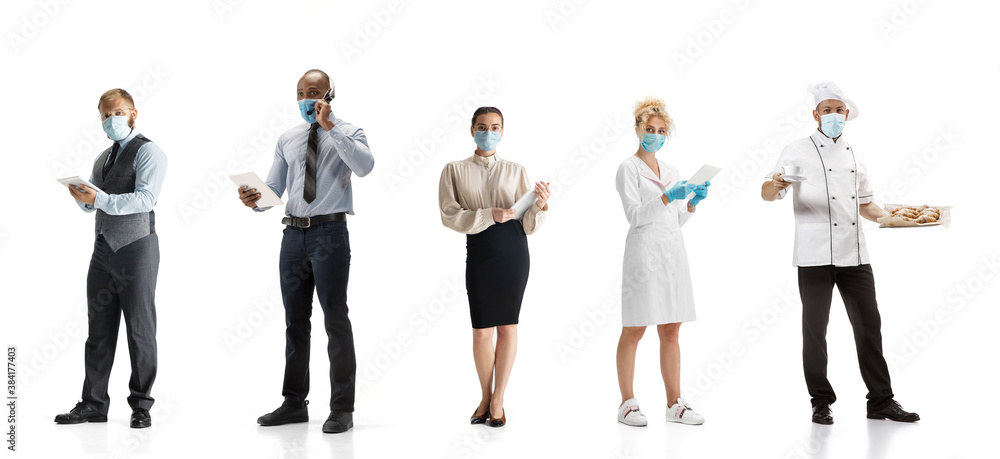 Obraz premium Group of people with different professions on white studio background, horizontal. Modern workers of diverse occupations, male and female models like accountant, cosmetologist, baker in face masks